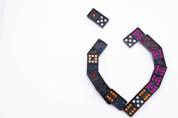 Connect black dominoes to form a heart.heart for love,Valentine's Day.