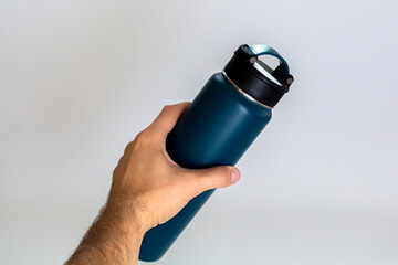Man holding a blue thermos. white background.