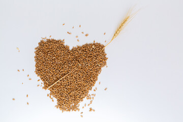 Grains wheat heart shape. White background.