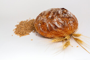Baked bread and wheat. White background.