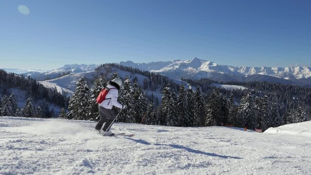 Woman Skier Skiing Down Slopes On Ski On Sunny Winter Day Background Mountains