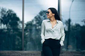 Business woman standing by the office building