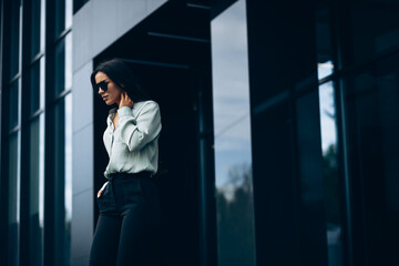 Business woman standing by the office building