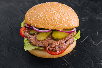 Tasty cheeseburger isolated on black stone