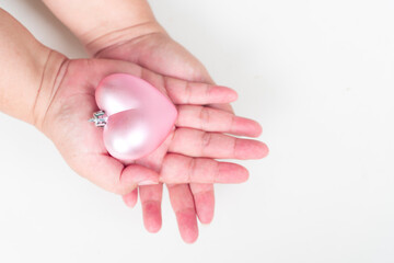 Pink heart shape on woman palm up on white background.  give love from me to all. sweet love couple valentine's day concept.