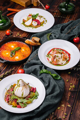 different types of italian dishes on a large wooden table
