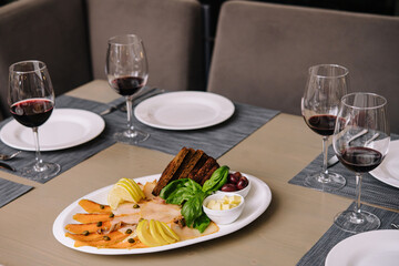 White and red smoked fish slices with glasses of wine