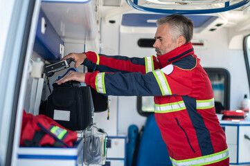 Doctor preparing the medical equipment for patient monitoring