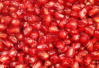 Ripe pomegranate seeds background. Many pomegranate seeds close up.