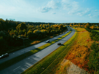 Aerial view on highway road with cars in evening time.