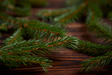 Christmas tree branches on the wooden background