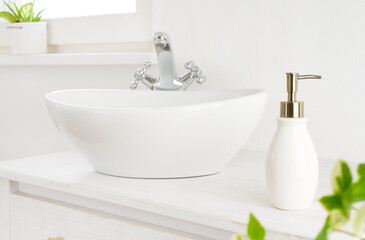 Hand washing concept with soap dispenser on washstand in bathroom