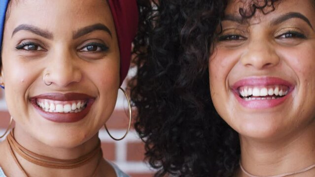 Portrait black women, identical twins and happy, smile or laughing latino people from Puerto Rico. Sisters, funny siblings and family woman faces of natural beauty, curly hair and happiness together