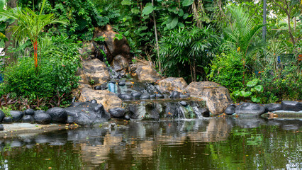 artificial waterfall at the city park. Hand made waterfall
