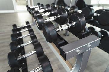 Obraz premium Dumbbells with sun light in fitness gym