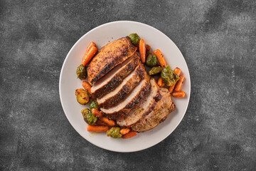 Roast pork with herbs and vegetables. Grilled sliced Pork Loin