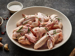 Uncooked chicken wings with spices. Raw meat. Raw Chicken wings.