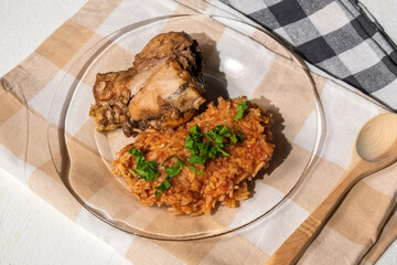 Bowl of east African Jollof Rice garnished with pieces of roasted chicken