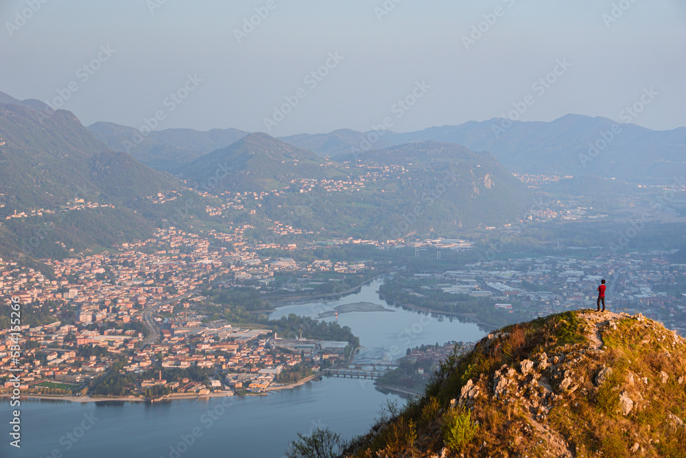 Wall mural the alps, lakes and cities of brianza seen in the sunset light from the top of mount Barro, near the town of lecco, Italy - April 2022.