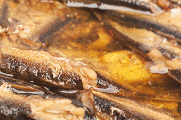 canned smoked sprats in oil texture background close-up