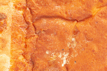 The texture of the crust of bread. Tasty fresh bread, close up.