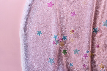 Stars Glitter Confetti on Beauty gel pink background. Shining highlighter texture with brush strokes