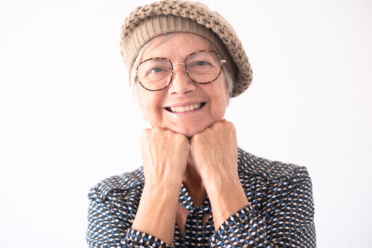 Close up portrait of beautiful elderly woman wearing glasses looking at camera smiling. Short haired caucasian lady in modern shirt feeling in a good mood