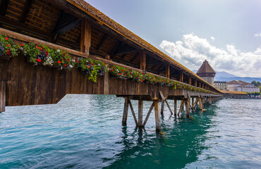 LUCERNE, SWITZERLAND, JUNE 21, 2022 - View of the wodden covered Kapellbrücke Bridge and its...
