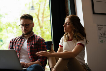  Young happy couple. Boyfriend and girlfriend drinking coffee together.