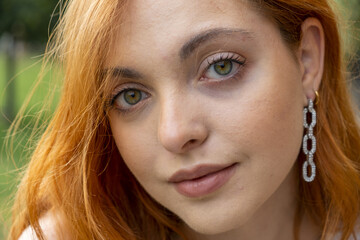Close-up of beautiful red-haired and green-eyed girl
