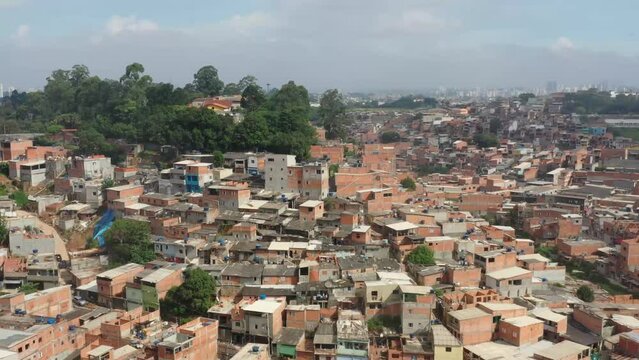 A drone shot of favela cantagalo in Rio de Janeiro. Residential buildings cramped together on a hill, creating a pattern of colorful buildings