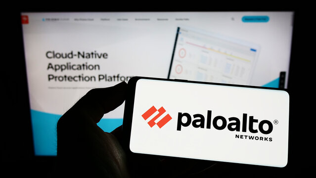Stuttgart, Germany - 09-24-2022: Person holding cellphone with logo of American cybersecurity company Palo Alto Networks Inc. on screen in front of webpage. Focus on phone display.
