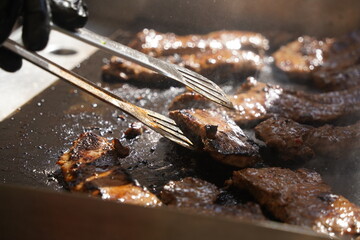 Roasting different pieces of beef for burgers and quesadillas.
