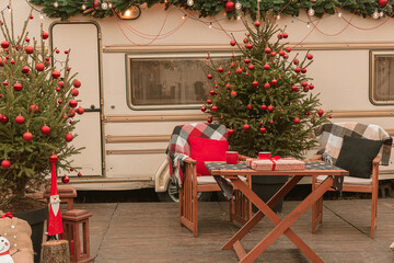 New Year's location near the motor home. Christmas holidays in nature. Christmas tree near the house.