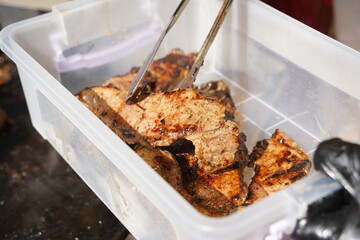 Roasting different pieces of beef for burgers and quesadillas.
