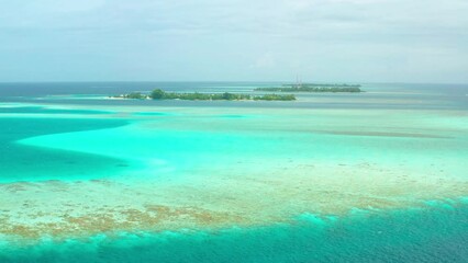 Aerial view of blue ocean with coral reef in Vaavu Atoll near Keyodhoo Island, Maldives.