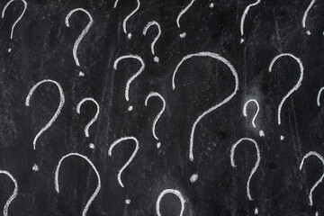 Question marks drawn with chalk on the school board
