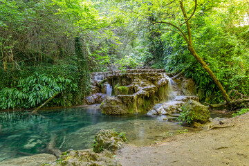 Fototapeta na wymiar Krushunski waterfalls with turqoize waters and beautiful ecosystem