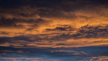 Fototapeta premium Sunset sky with orange clouds. Nature background.
