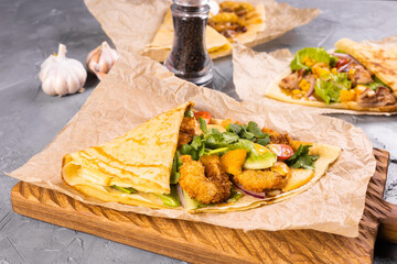 Pancake or crepe with fried shrimp tomatoes and vegetables and cheese