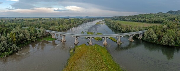 View of a bridge over the river Po in Piedmont in the drought summer of 2022 at low water level