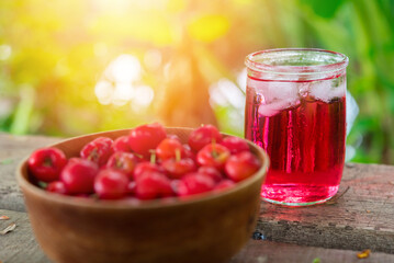 Glass of sour cherry juice with fresh red cherries, Cherry juice, on wood background, red drink, High vitamin C and antioxidant fruits.