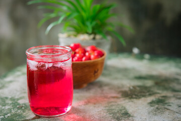 Glass of sour cherry juice with fresh red cherries, Cherry juice, on wood background, red drink, High vitamin C and antioxidant fruits.