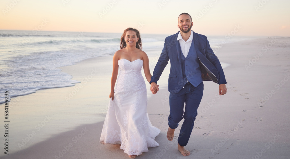 Poster Wedding, couple and beach with a man and woman holding hands while walking on the sand by the ocean or sea. Love, trust and marriage with a bride and groom on the coast at sunset for celebration