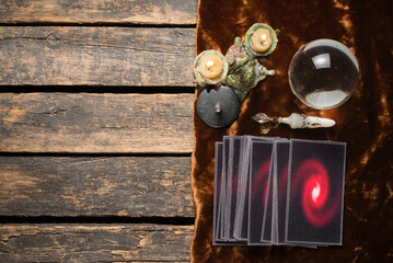 Tarot cards and crystal ball on the old fortune teller desk table background. Future reading concept.