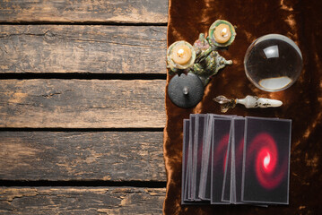 Tarot cards and crystal ball on the old fortune teller desk table background. Future reading concept.