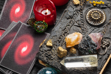 Tarot cards and magic book on the old fortune teller desk table background. Future reading concept.