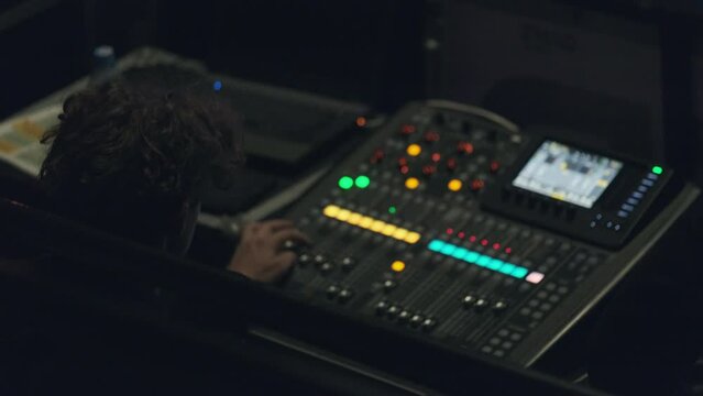 Sound engineer using laptop during work