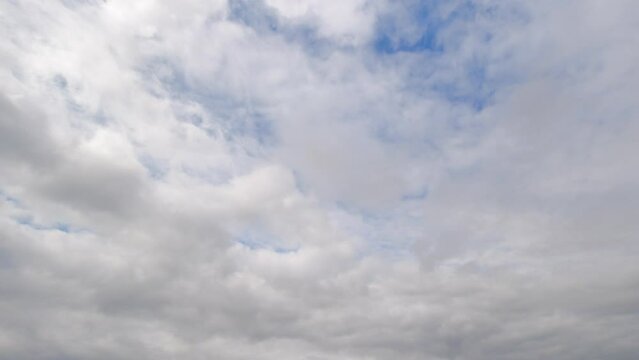 Static timelapse of the clouds passing by and revealing the stunning blue sky