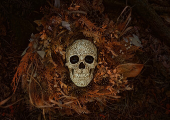 Decorative skull and dry autumn leaves on dark natural background. symbol of Halloween holiday,...